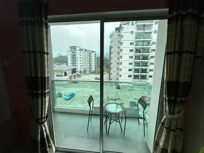 a room with a balcony with a view of a pool at Family Stay at Quintet A3A-3A-6 in Tanah Rata