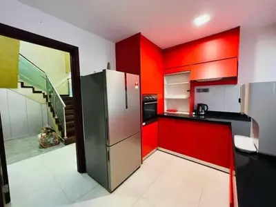 a kitchen with red cabinets and a stainless steel refrigerator at Shamplex Rentals in Kampar