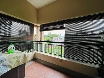 a room with a balcony with a table and two windows at Shamplex Rentals in Kampar