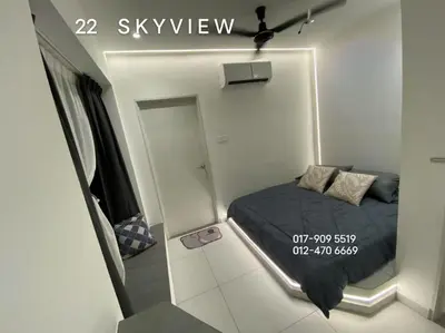 a small bedroom with a bed and a mirror at 22 Skyview in Bukit Mertajam