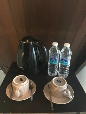 a table with two cups and two bottles of water at KK Farm Stay in Ringlet