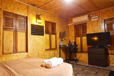 a bedroom with a bed and a flat screen tv at Aeden Villa Roomstay & Homestay in Kuala Kangsar