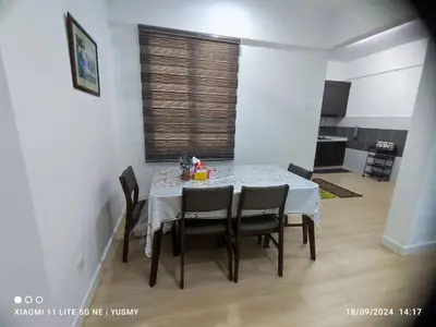 a dining room table and chairs in a room at 3 Bedroom Apartment YuCasa Sg Nibong Penang in Bayan Lepas
