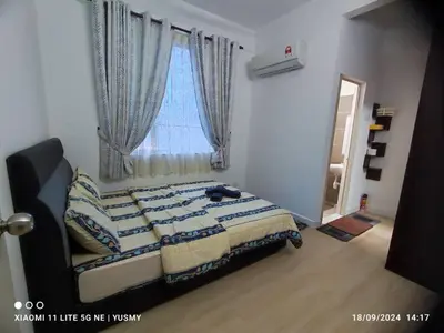 a bedroom with a bed with a window and a mirror at 3 Bedroom Apartment YuCasa Sg Nibong Penang in Bayan Lepas
