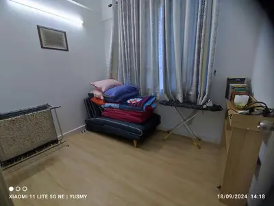 a living room with a couch in front of a window at 3 Bedroom Apartment YuCasa Sg Nibong Penang in Bayan Lepas