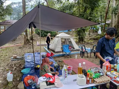 a man and a woman standing in front of a tent at Camp Site in Tapah