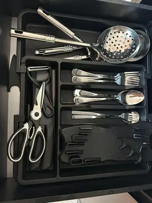 a drawer full of utensils in a black container at ICC Premier Suites Ipoh City Centre by Landmark in Ipoh