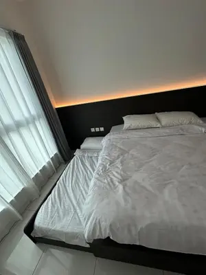 a bedroom with a large white bed and a window at ICC Premier Suites Ipoh City Centre by Landmark in Ipoh