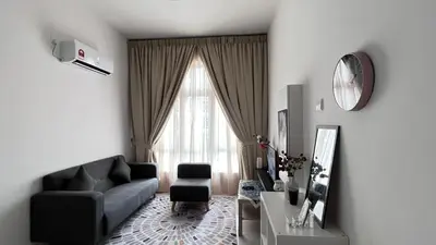 a living room with a couch and a window at ANAS Homestay in Ipoh