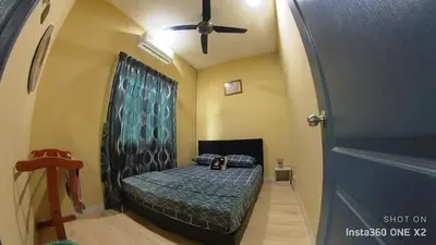 a bedroom with a bed in a room with a ceiling fan at Ss homestay in Seri Manjung
