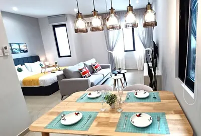 a living room with a dining table and a bedroom at LS Iconic Regency #Queensbay Mall#FIZ#Airport in Bayan Lepas
