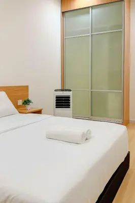 a bedroom with a large white bed with a glass door at Taiping Peaceful Retreat near Lake Garden with WiFi in Taiping