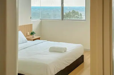 a bedroom with a large white bed in front of a window at Taiping Peaceful Retreat near Lake Garden with WiFi in Taiping