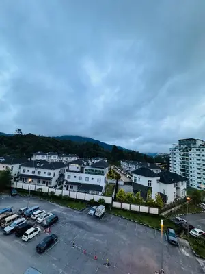 a parking lot with cars parked in a city at AYAAN HOMESTAY HILL VIEW INN 2 FREE Wifi and Netflix in Cameron Highlands