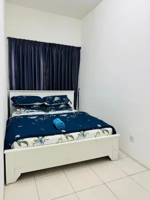 a white bed with blue sheets and blue pillows at AYAAN HOMESTAY HILL VIEW INN 2 FREE Wifi and Netflix in Cameron Highlands