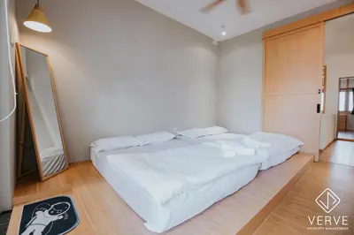 a bedroom with a large bed with white sheets at The Time Capsule 4B3B BY Verve 12 Pax in Ipoh