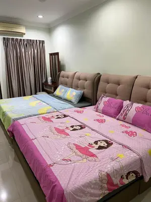 a bedroom with two beds with a pink blanket at KKB Gathering Home - ENTIRE HOME in Kuala Kubu Baharu