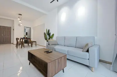 a living room with a blue couch and a table at Modern Studio Retreat -Prime Location Brinchang Clover Home 1-03 in Brinchang