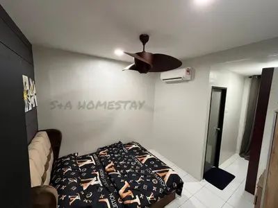 a bedroom with a bed and a ceiling fan at S&A Homestay in Sungai Petani
