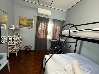 a bedroom with two bunk beds and a desk at Canning Garden-The Ipohscape in Ipoh