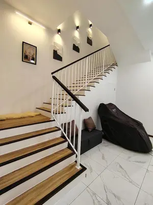 a staircase in a house with a suitcase on the floor at D Banyan Homestay, Sungai Petani, EV Friendly Stay, FREE 22kW in Sungai Petani