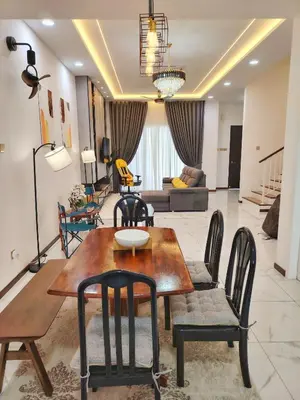 a living room with a wooden table and chairs at D Banyan Homestay, Sungai Petani, EV Friendly Stay, FREE 22kW in Sungai Petani