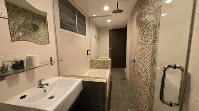 a white bathroom with a sink and a shower at Okay Marina Lumut Homestay in Lumut