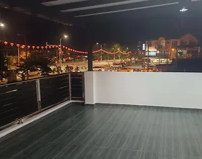a balcony with a view of a city at night at SR Kampar 2-Storey LANDED HOMESTAY in Kampar