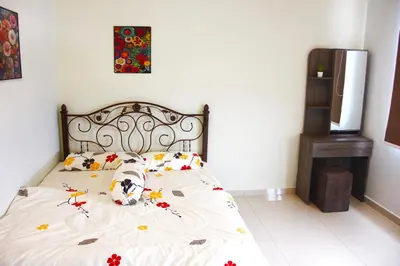 a bedroom with a bed with flowers on it at Classic Spot - Meru Raya in Ipoh