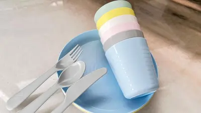 a blue plate with cutlery and a fork and knife at Single Terrace at Canning Ipoh Newly Renovated in Ipoh