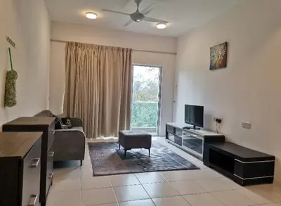a living room with a couch and a television at Ummu's homestay in Tanah Rata