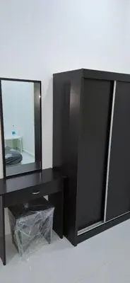 a black cabinet with a mirror on top of it at D'Intan Villa Gerik in Gerik