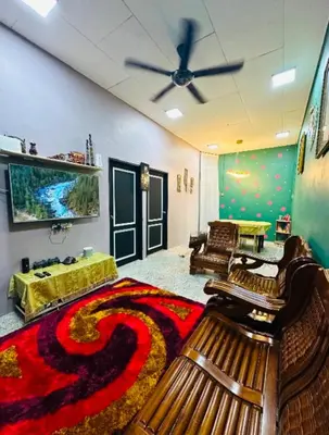 a living room with a couch and a rug at M&M Bendi Homestay in Lunas
