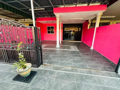 a building with a pink wall and a potted plant at M&M Bendi Homestay in Lunas