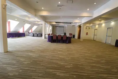 a large room with purple tables and chairs at Iris House Hotel Cameron Highlands in Brinchang