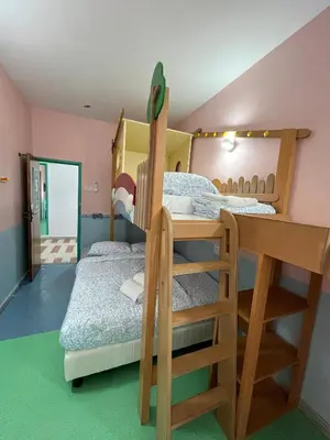 a bedroom with two bunk beds and a desk at Hippo House Taiping in Taiping
