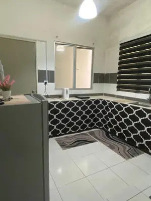 a bathroom with a black and white tile floor at Wan AyuRa Homestay in Tanah Rata