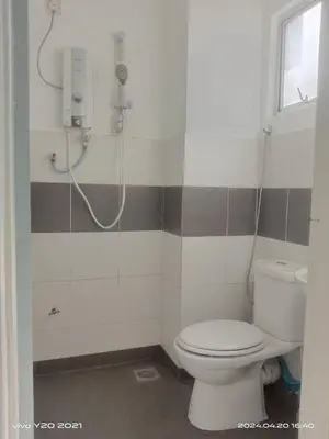 a bathroom with a toilet and a shower at Wan AyuRa Homestay in Tanah Rata