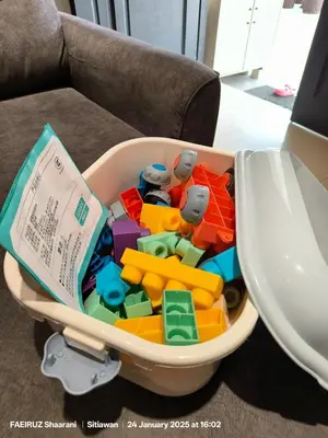a toy bin filled with legos and a book at Taman Sejati Sitiawan Cumi Home 4BR with pool, BBQ in Sitiawan