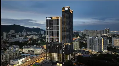 a tall building with lights on in a city at Wanderlust Retreat in Bayan Lepas