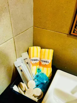 a box of towels on a counter next to a sink at Stunning Sea & City View Apartment in George Town in Jelutong