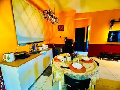 a kitchen with a table with plates on it at Stunning Sea & City View Apartment in George Town in Jelutong