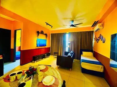a living room with a couch and a table in a room at Stunning Sea & City View Apartment in George Town in Jelutong