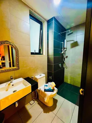 a bathroom with a sink and a toilet and a mirror at Deluxe Suite for10 Stunning Sea &City ViewsNetflix in Jelutong