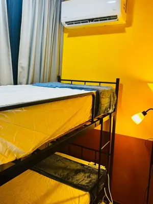 two bunk beds in a room with a air conditioner at Deluxe Suite for10 Stunning Sea &City ViewsNetflix in Jelutong