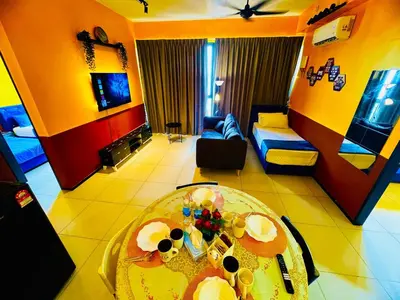 a living room with a table and a couch at Deluxe Suite for10 Stunning Sea &City ViewsNetflix in Jelutong