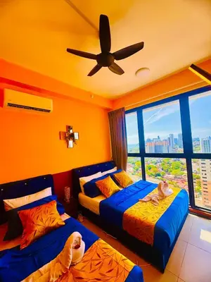 a bedroom with two beds and a ceiling fan at Deluxe Suite for10 Stunning Sea &City ViewsNetflix in Jelutong