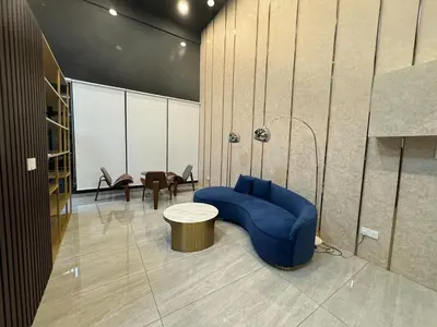 a room with a blue couch and a table and chairs at Deluxe Suite for10 Stunning Sea &City ViewsNetflix in Jelutong