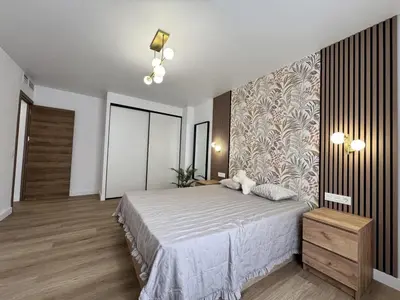 a bedroom with a bed and a wall at Penginapan Jolra S3 in Sungai Petani