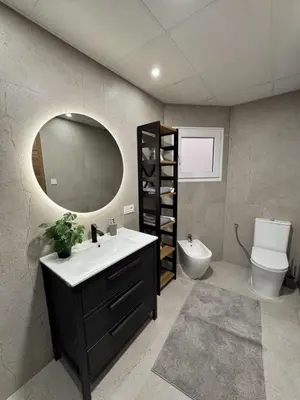 a bathroom with a sink and a mirror and a toilet at Penginapan Jolra S3 in Sungai Petani